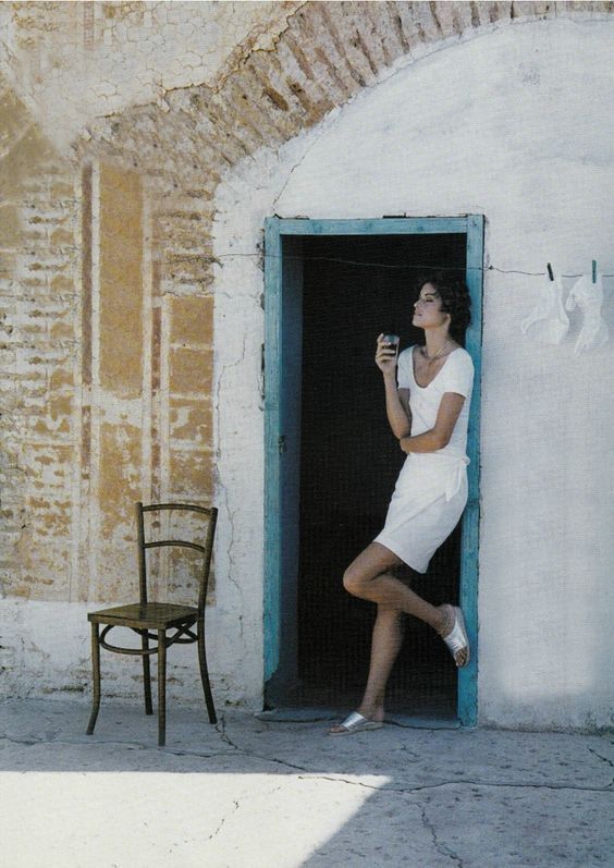 Woman standing in a weathered European doorway